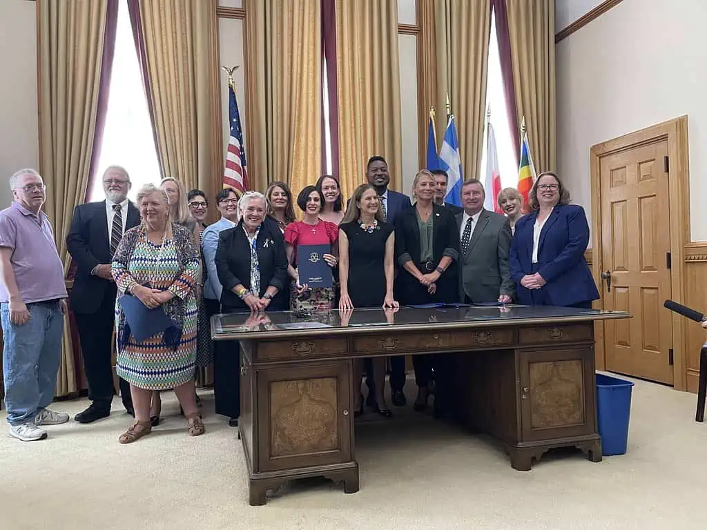 Advocates and survivors stand with Lt. Gov. Susan Bysiewicz after she signed the bill to end child marriage in Connecticut.
